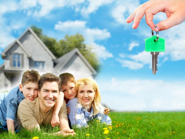 Happy family near new home. Mortgage concept.