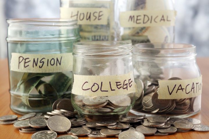 Bottles of cash with coins isolated on the background.